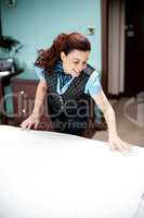 Housekeeping executive making the bed ready