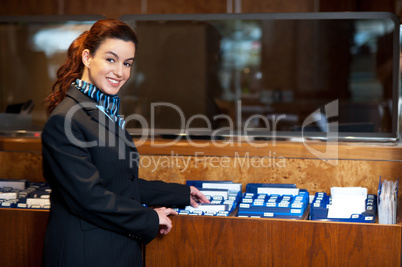 Front office female assistant checking customer records