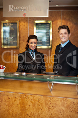 Trendy adorable couple at front office desk