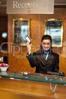 Beautiful receptionist posing with customers cash card