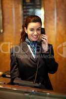 Stylish female attendant at hotel reception
