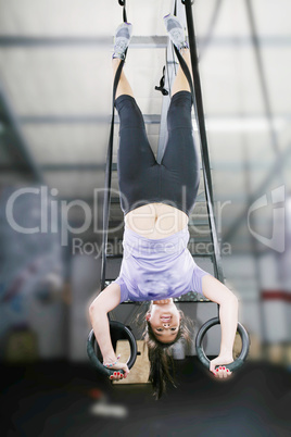 carries out difficult exercise, sports gymnastics with a dark ba