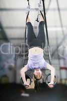 carries out difficult exercise, sports gymnastics with a dark ba