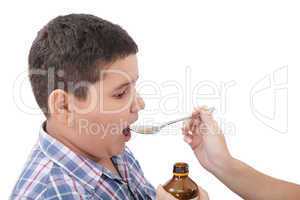 Child taking cough medicine because of the flu