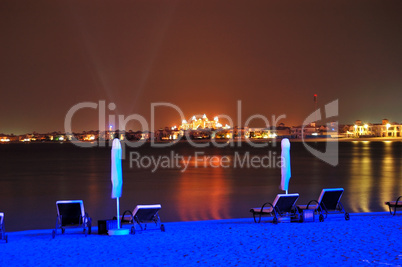 Beach of luxury hotel in night illumination on Palm Jumeirah man