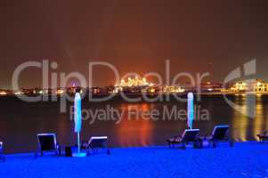Beach of luxury hotel in night illumination on Palm Jumeirah man