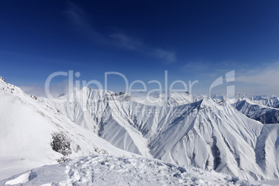 Winter mountains and blue sky