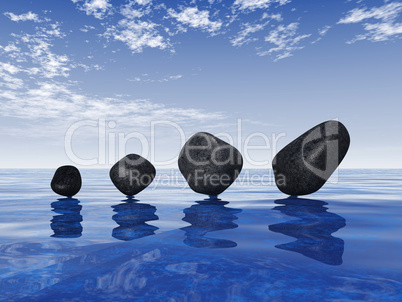 Black stones on blue water 2