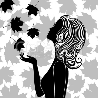 Silhouette of young woman with flying leaves