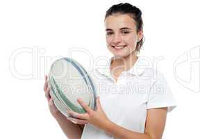 Attractive sporty girl posing with rugby ball