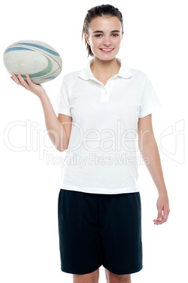 Lovely isolated caucasian teenager with a football