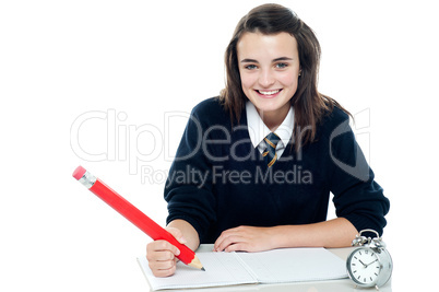 Profile shot of smiling school girl taking down notes
