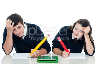 Confused students holding their heads during examination