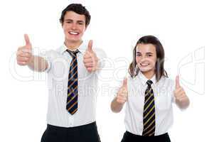 Students showing thumbs up to camera