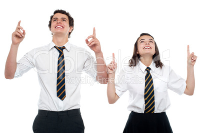 Schoolmates looking and pointing upwards