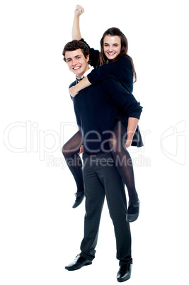 Schoolgirl cheering with raised arm during piggy ride