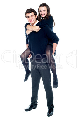 Schoolboy carrying girl on his back