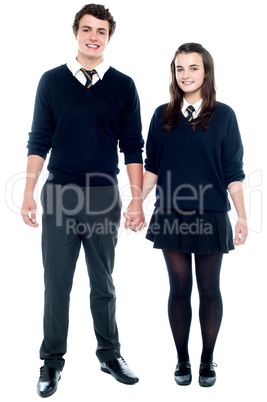 School friends in uniform holding hands