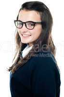 Side view of an adorable teenager wearing spectacles