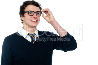 Smiling student adjusting his spectacles