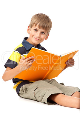 Schoolboy is holding a book on white