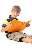 Schoolboy is holding a book on white