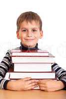 Schoolboy and a heap of books isolated on a white background