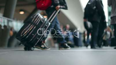 Passengers with luggage at a modern Station in 1080p HD with bokeh