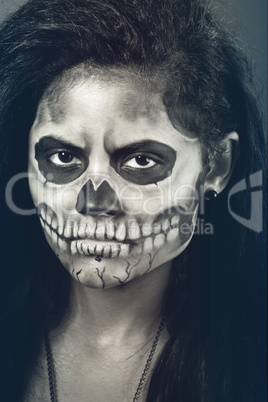 Young woman in day of the dead mask skull. Halloween face art