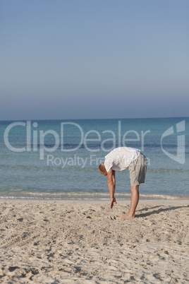 Mann macht yoga Sport am Strand Hochformat