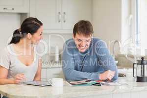 Two people sitting in the kitchen and chatting