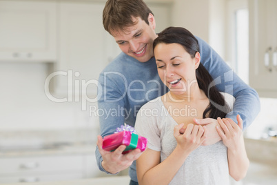 Man offering a present to his wife