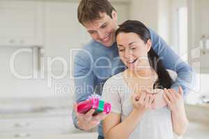 Man offering a present to his wife