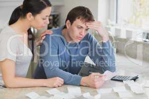 Worried couple looking over bills
