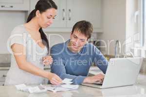 Young couple calculating with the laptop