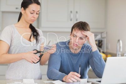 Woman cutting through a credit card