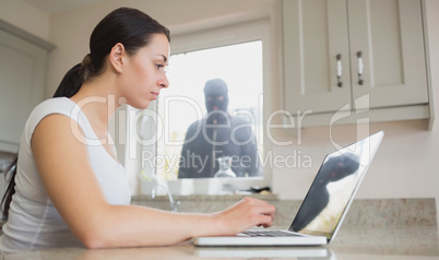 Young woman seeing reflection of robber