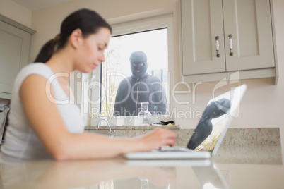 Young woman observed in the kitchen