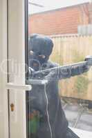 Burglar opening door with crow bar