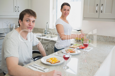 Happy couple having lunch in kitchen