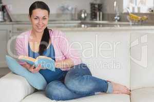 Young reading woman in the living room