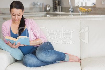 Young woman relaxing while reading a book