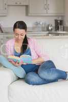 Young woman reading in the living room