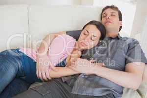 Young couple sleeping on the couch