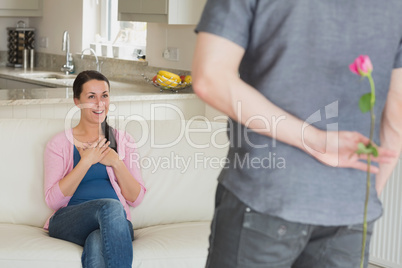 Man surprising wife with flower