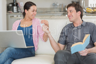 Young couple having fun while sitting on the couch