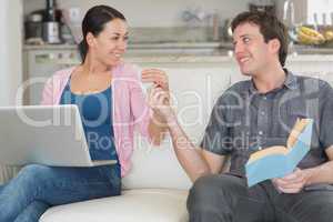 Young couple having fun while sitting on the couch