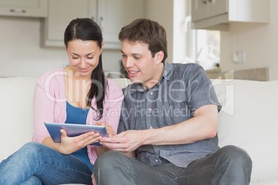 Two people using a tablet computer