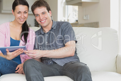 Couple having fun with the tablet computer