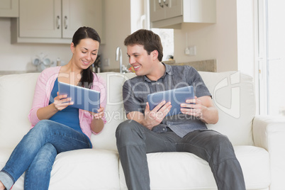 Two friends working with their tablet computers